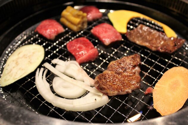 Affordable Kobe beef in Kobe shot of meat cooking on grill with vegetables