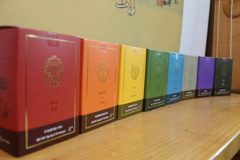 an array of teas grown in Korea in rainbow colors of boxes.