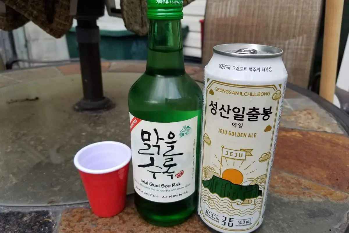 empty red cup, soju bottle, and korean beer in can.