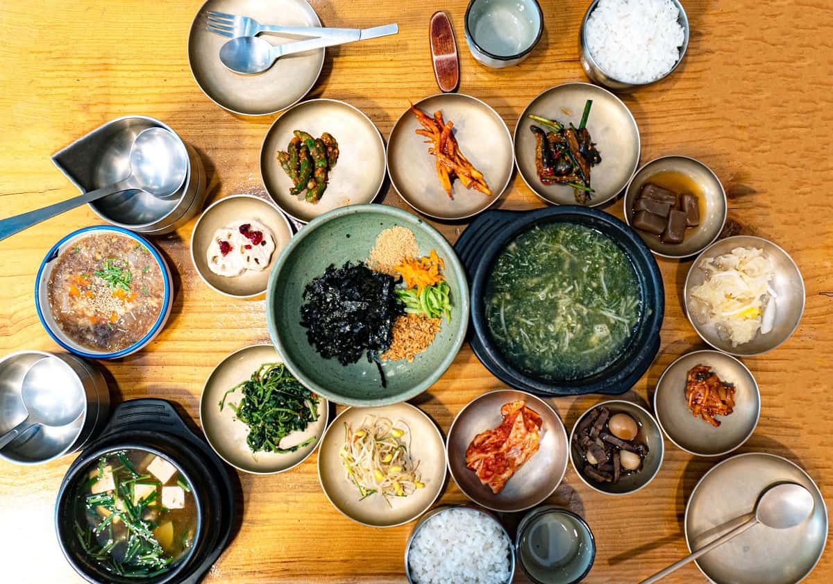 Korean style dishes of soup and pickled vegetables.