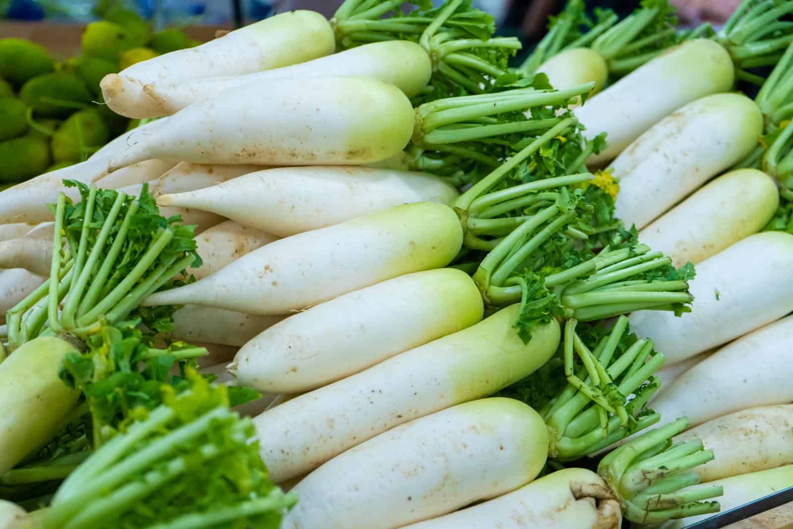 A radish counter in the grocery store's vegetable section.
