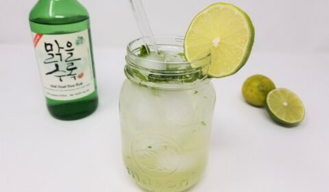 a mason jar of refreshingly cool glass of mojito made with soju and garnished with fresh mint