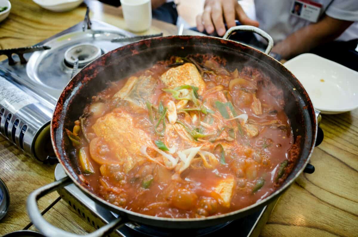 Cooking fish soup in a deep pan.