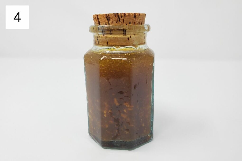 a mixture of ginger yuzu salad dressing in a glass container