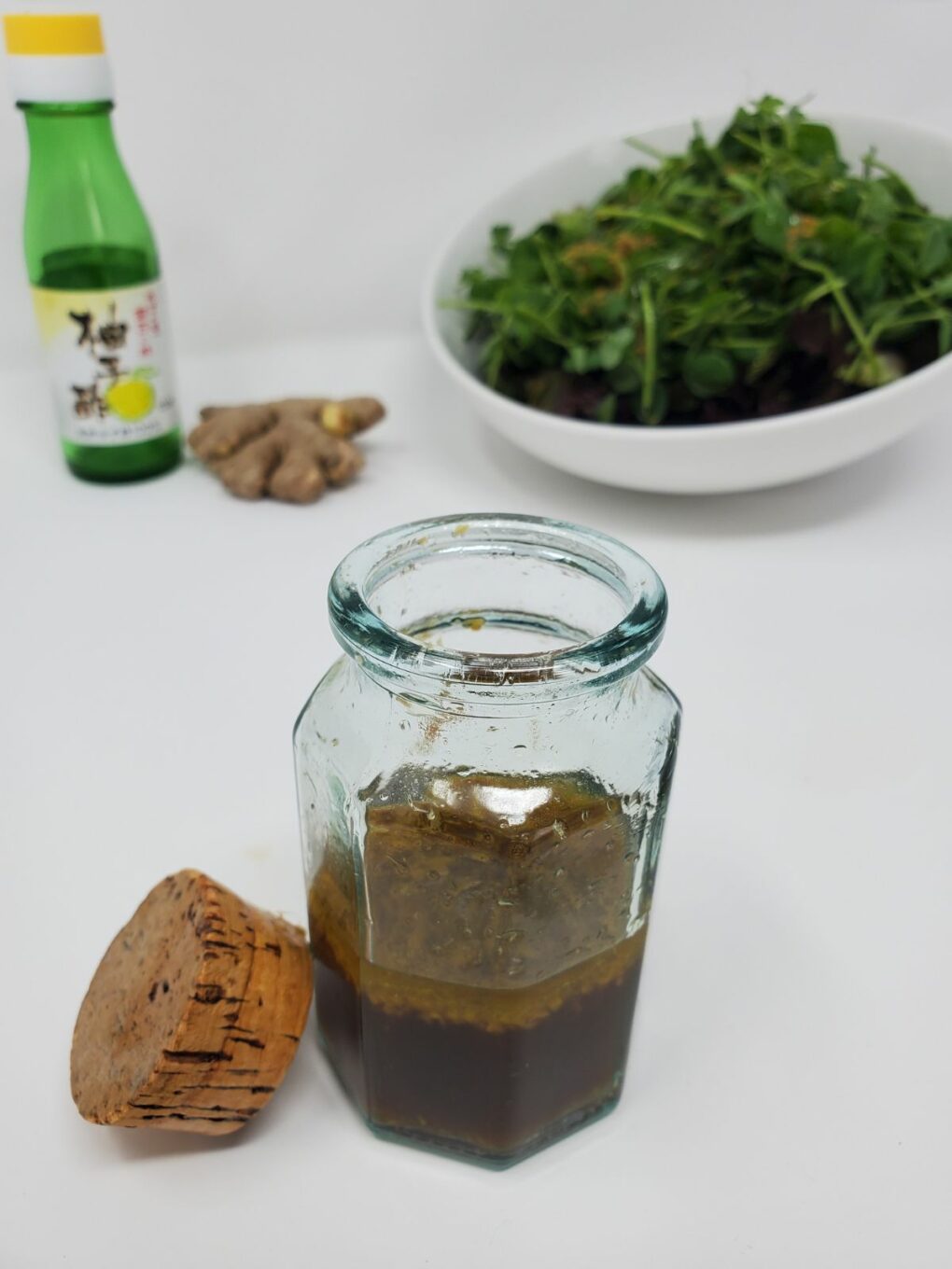 a mixture of ginger yuzu salad dressing in a glass container
