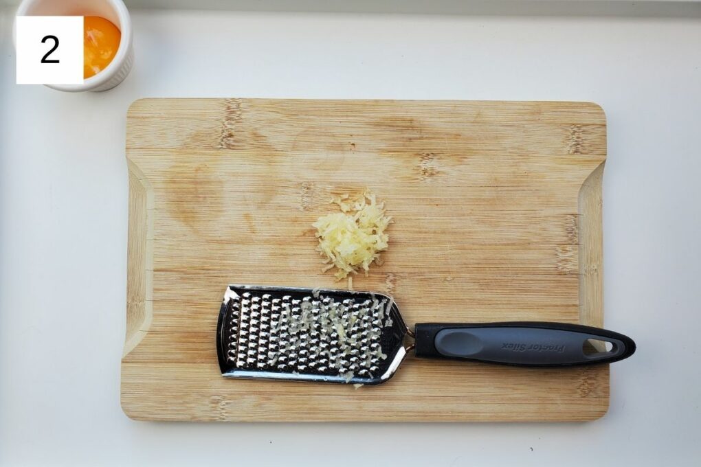 minced garlic on a wooden chopping board