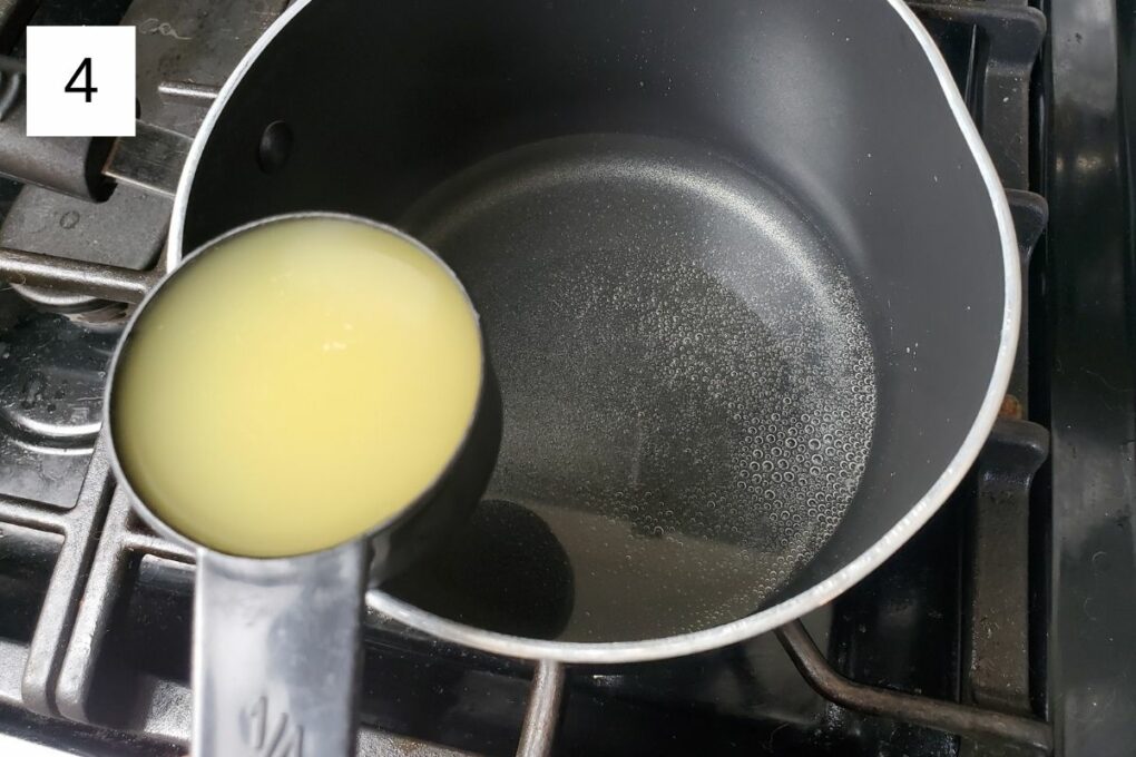 a cup of yuzu juice concentrate and a mixture of water and sugar in a pot