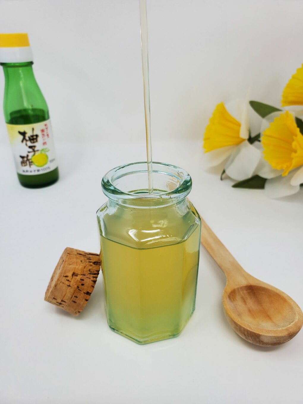 filling a glass container with yuzu simple syrup