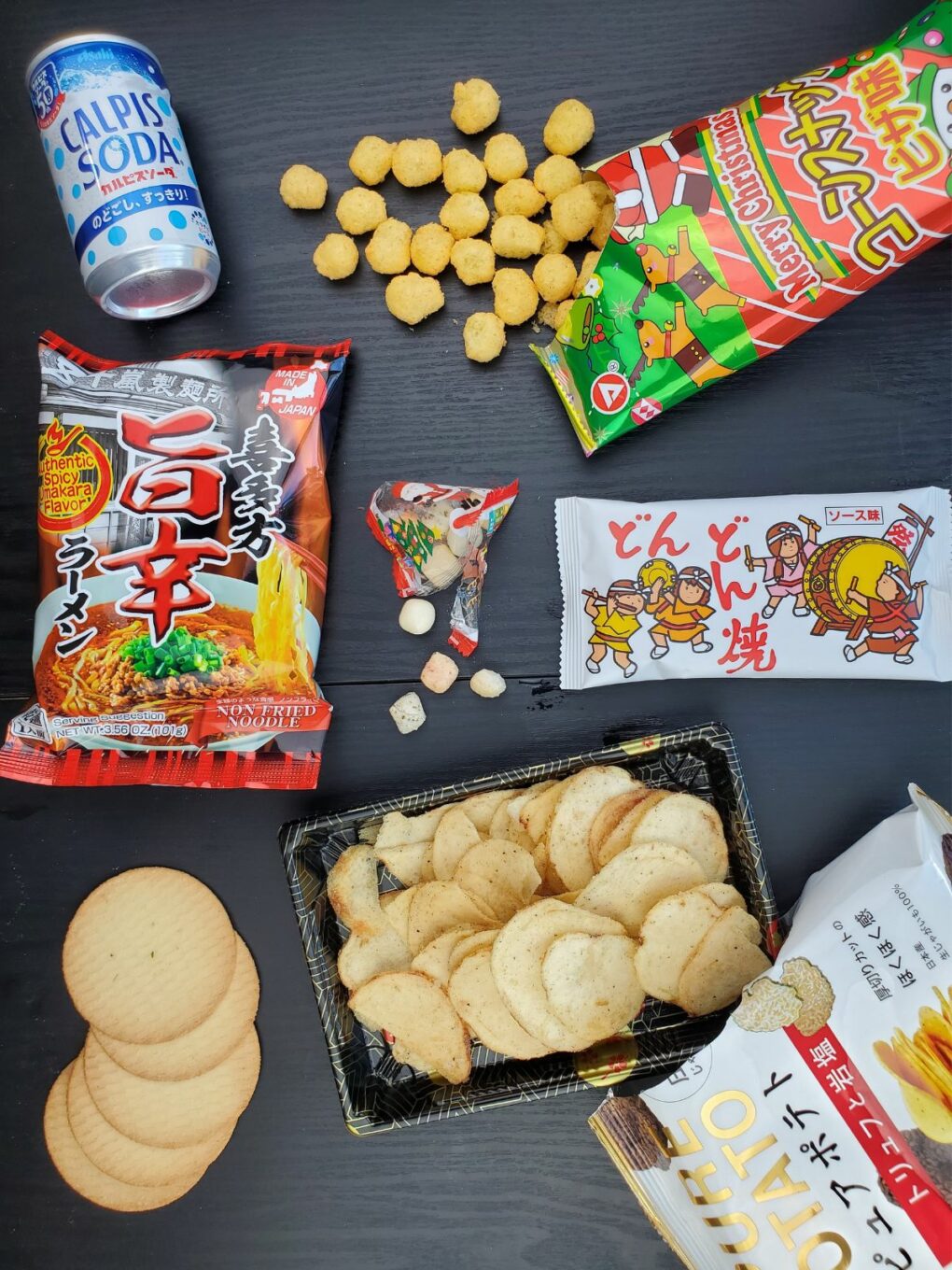 all of the savory tokyo treats snacks laid out on the table, some of them unwrapped.
