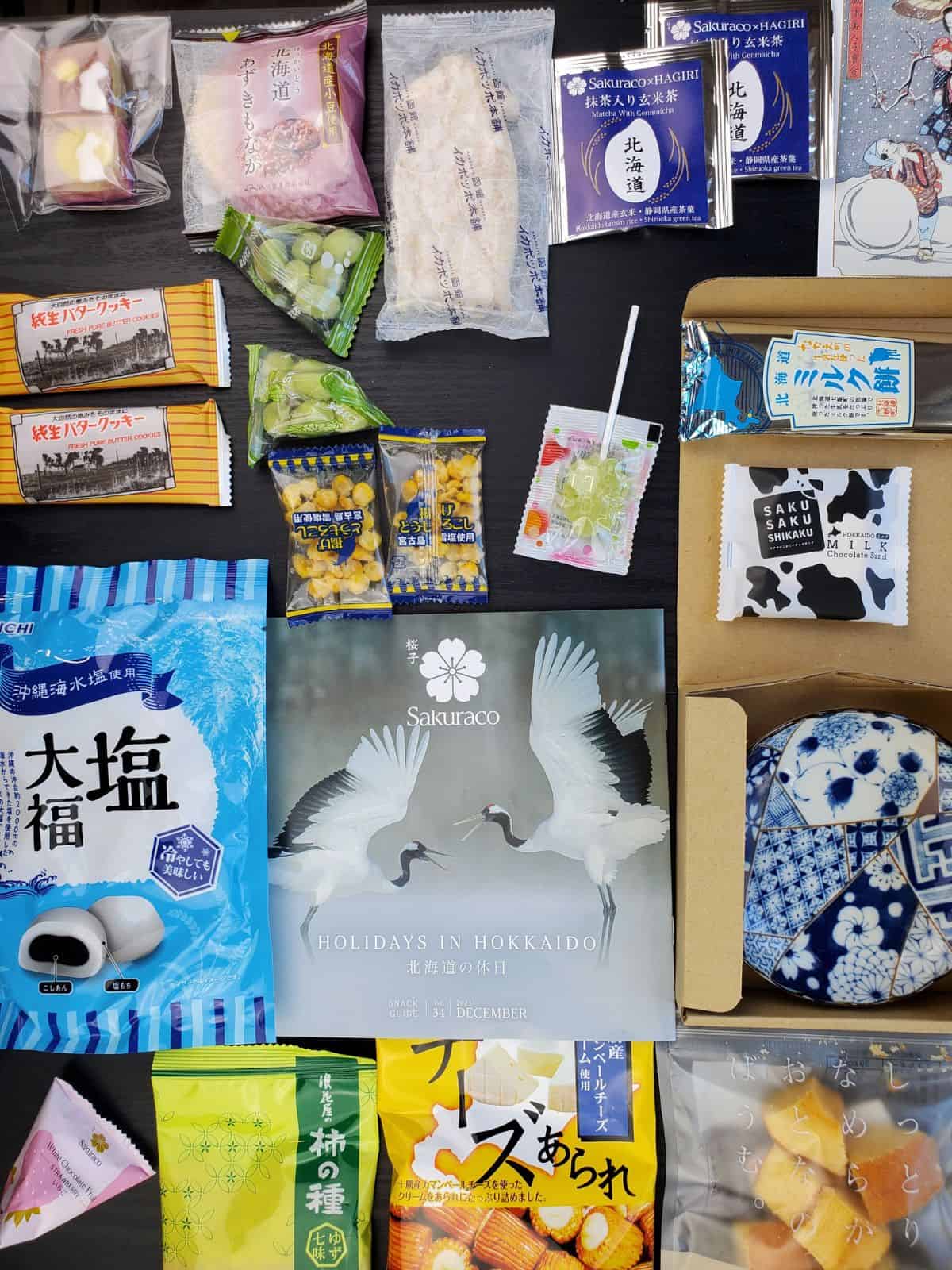 all of the sakuraco snacks laid out on the table.