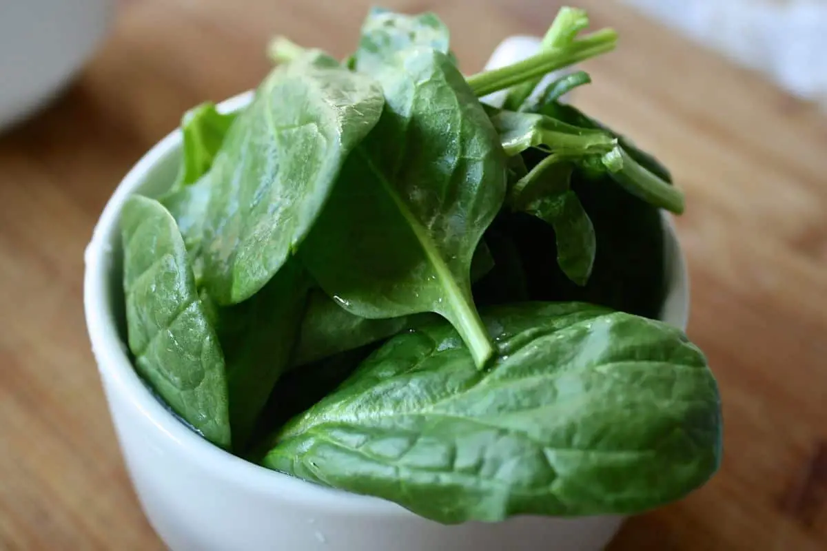 A bowl of spinach.