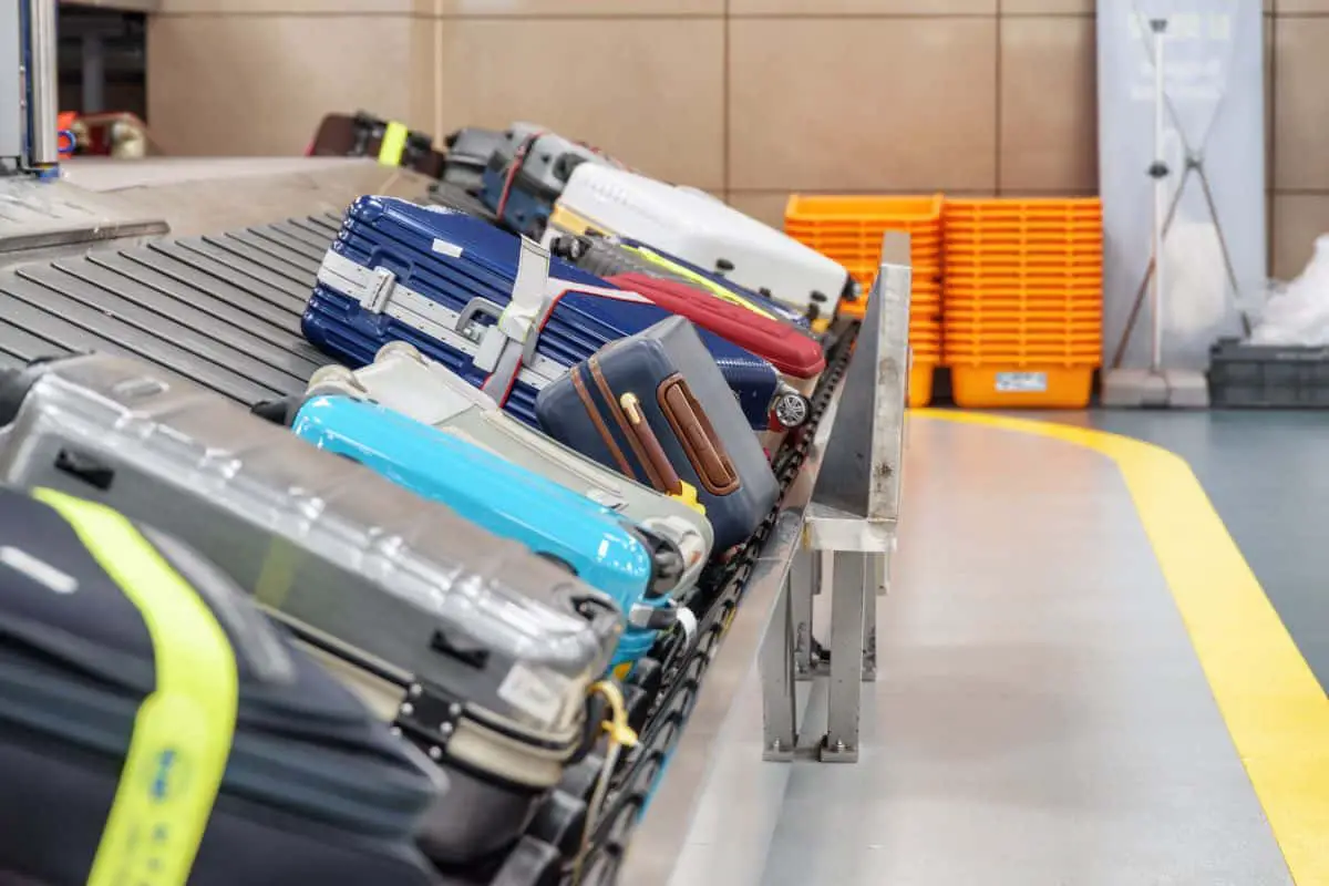 Suitcases on luggage conveyor belt in airport. 
