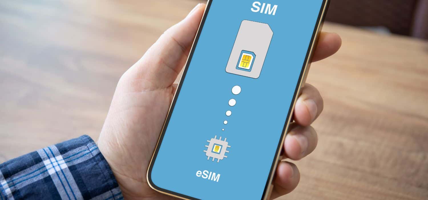 person's hand holding a phone with an esim loading on it.