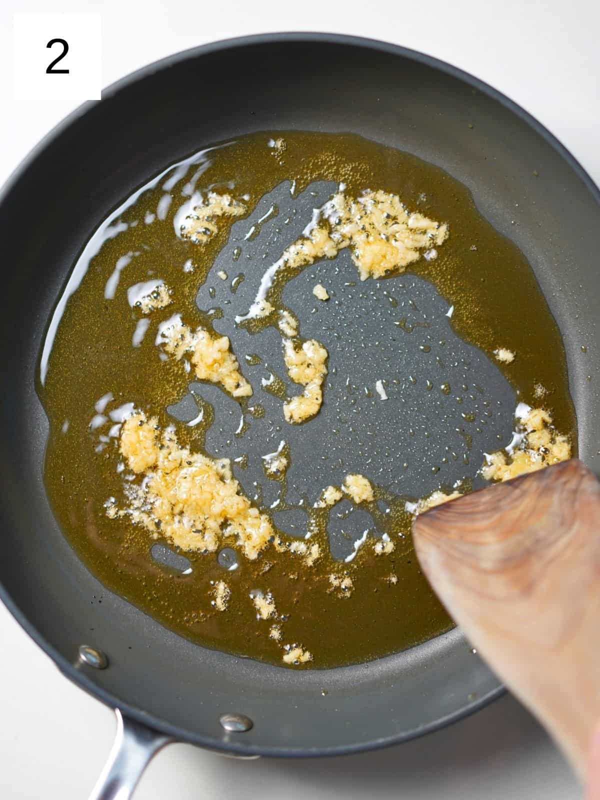 Oil in a frying pan with garlic.