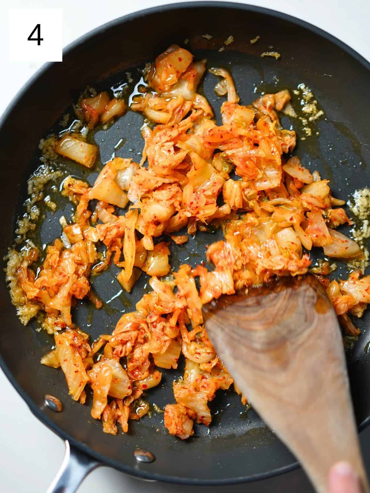 Kimchi and tuna in a frying pan.