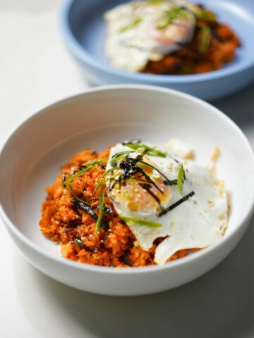 kimchi fried rice in a bowl topped with egg.