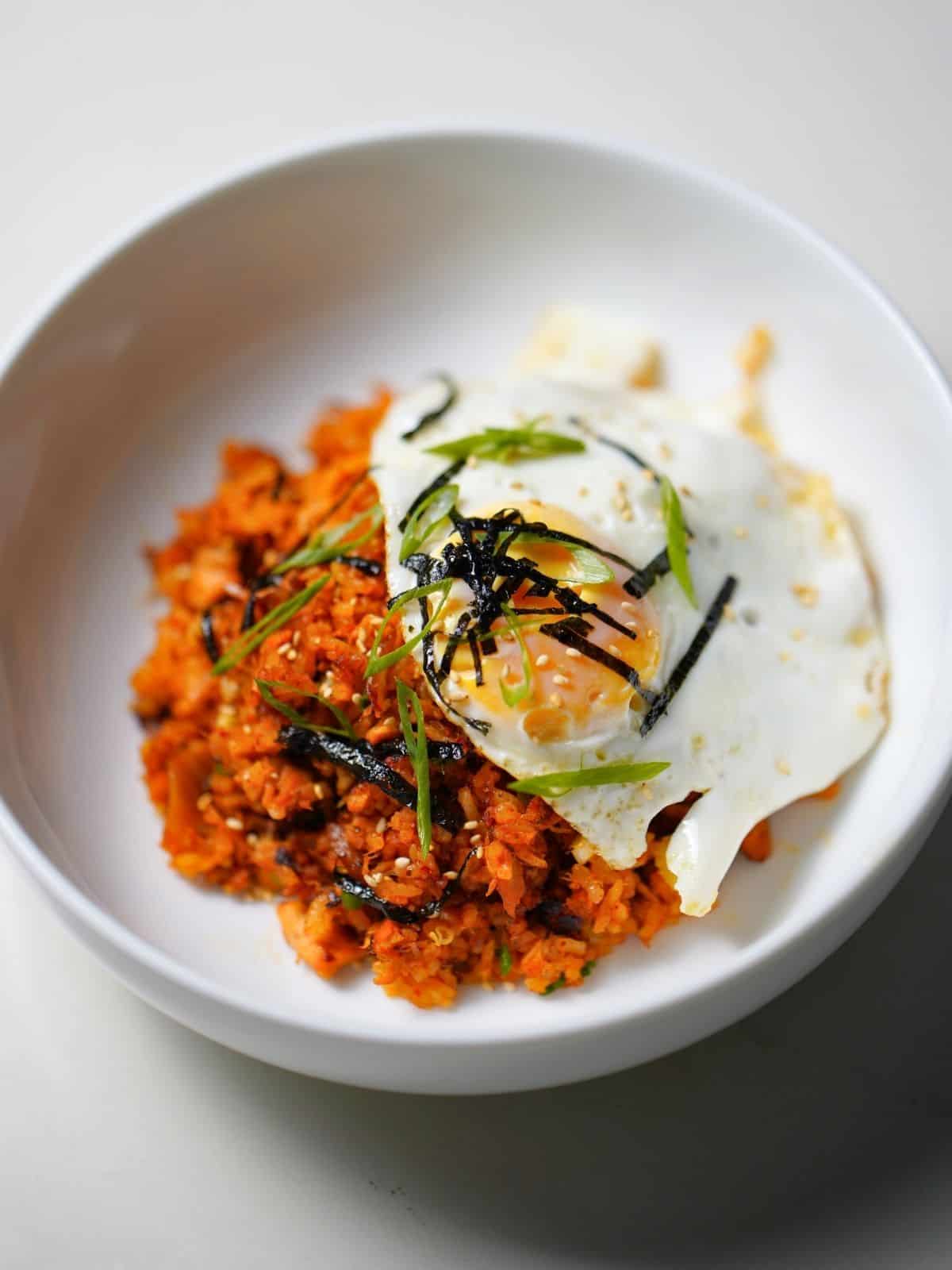 kimchi fried rice in a bowl topped with egg.