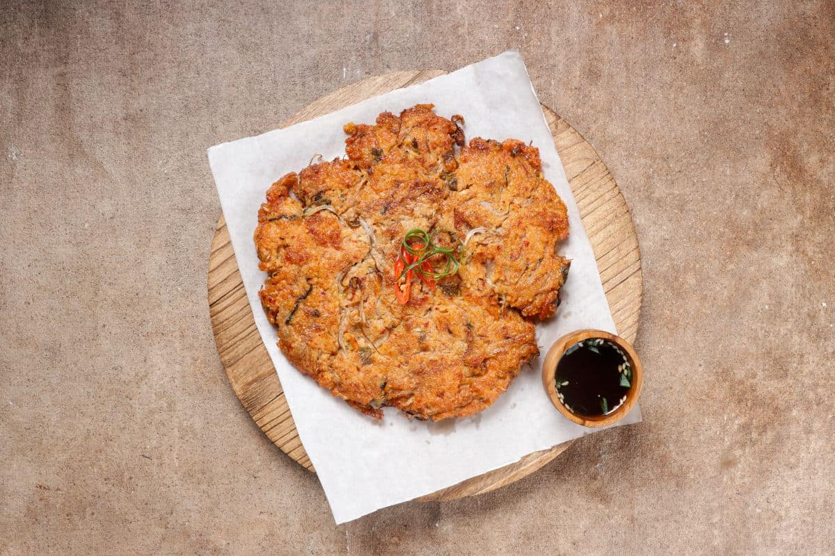 Nokdujeon or mungbean pancake served in a wooden platter.