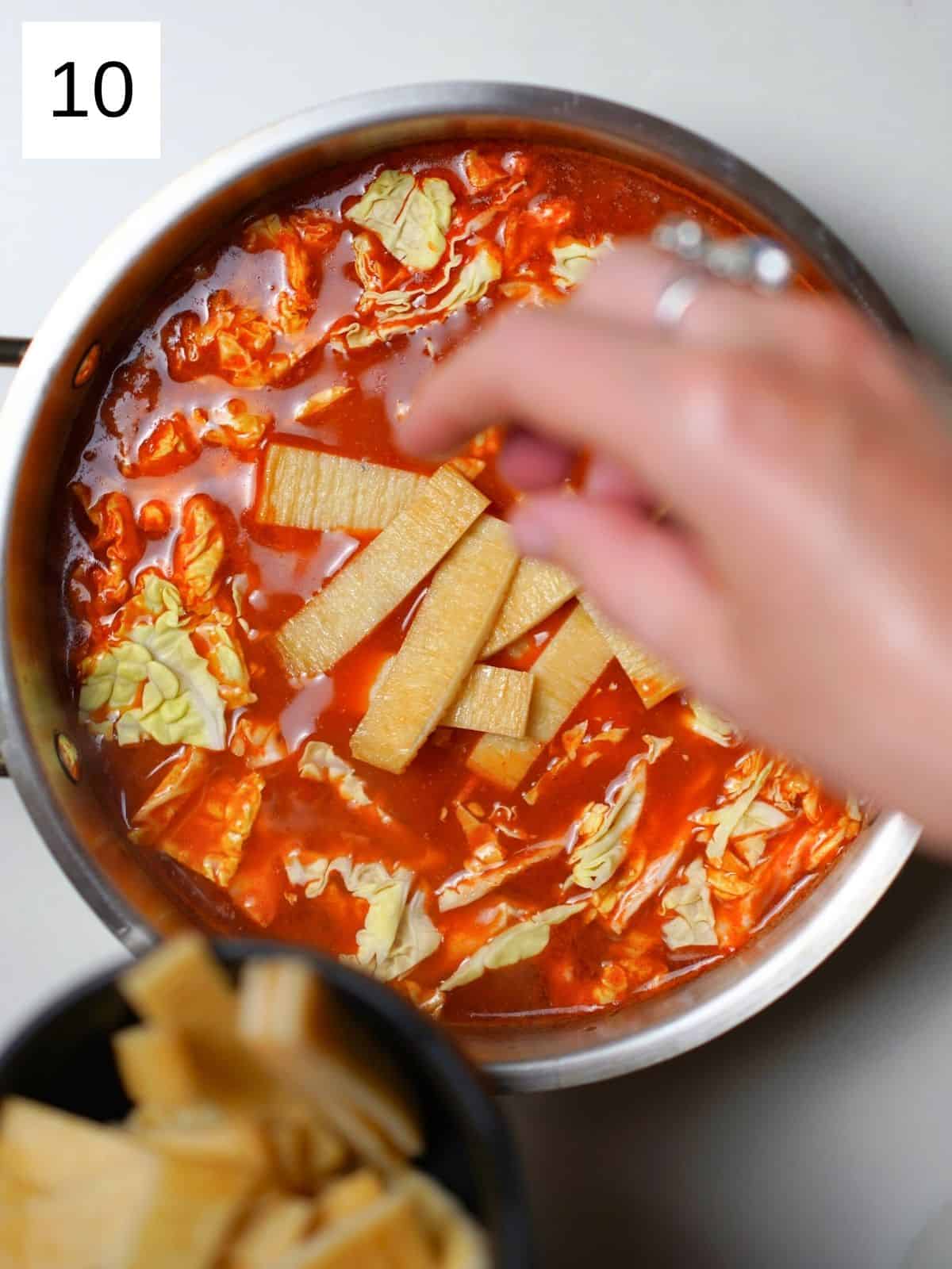 Cooking rabokki in a bowl.