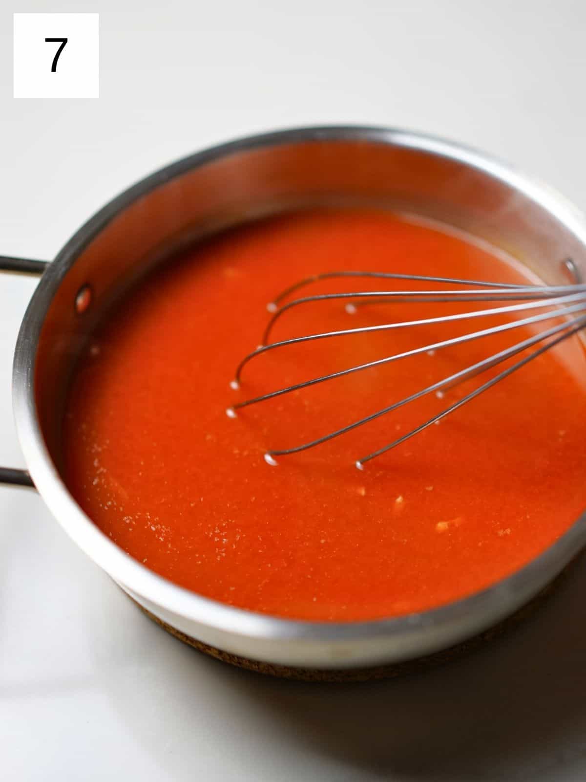 red sauce/broth in a bowl.