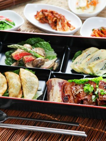 A Korean lunch box packed with food.