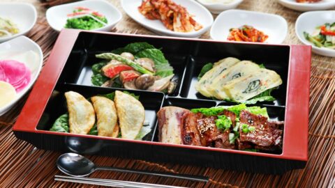 A Korean lunch box packed with food.