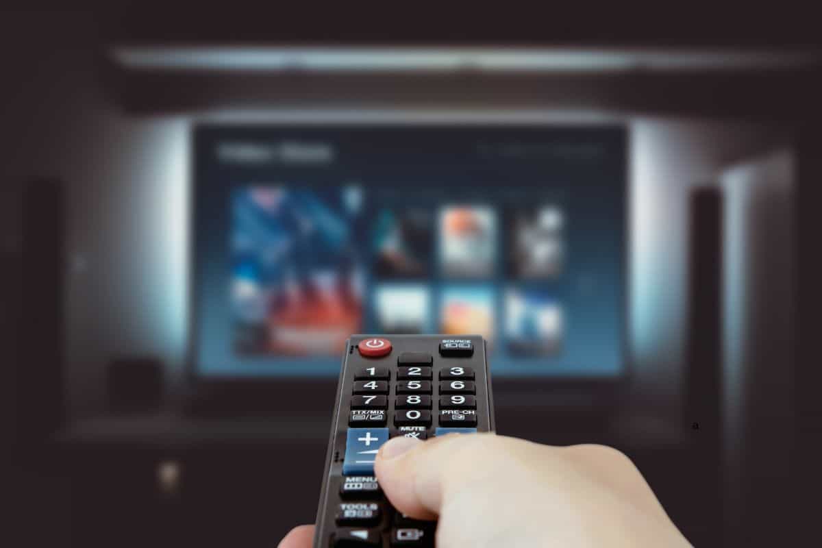 Remote control with TV on the background.