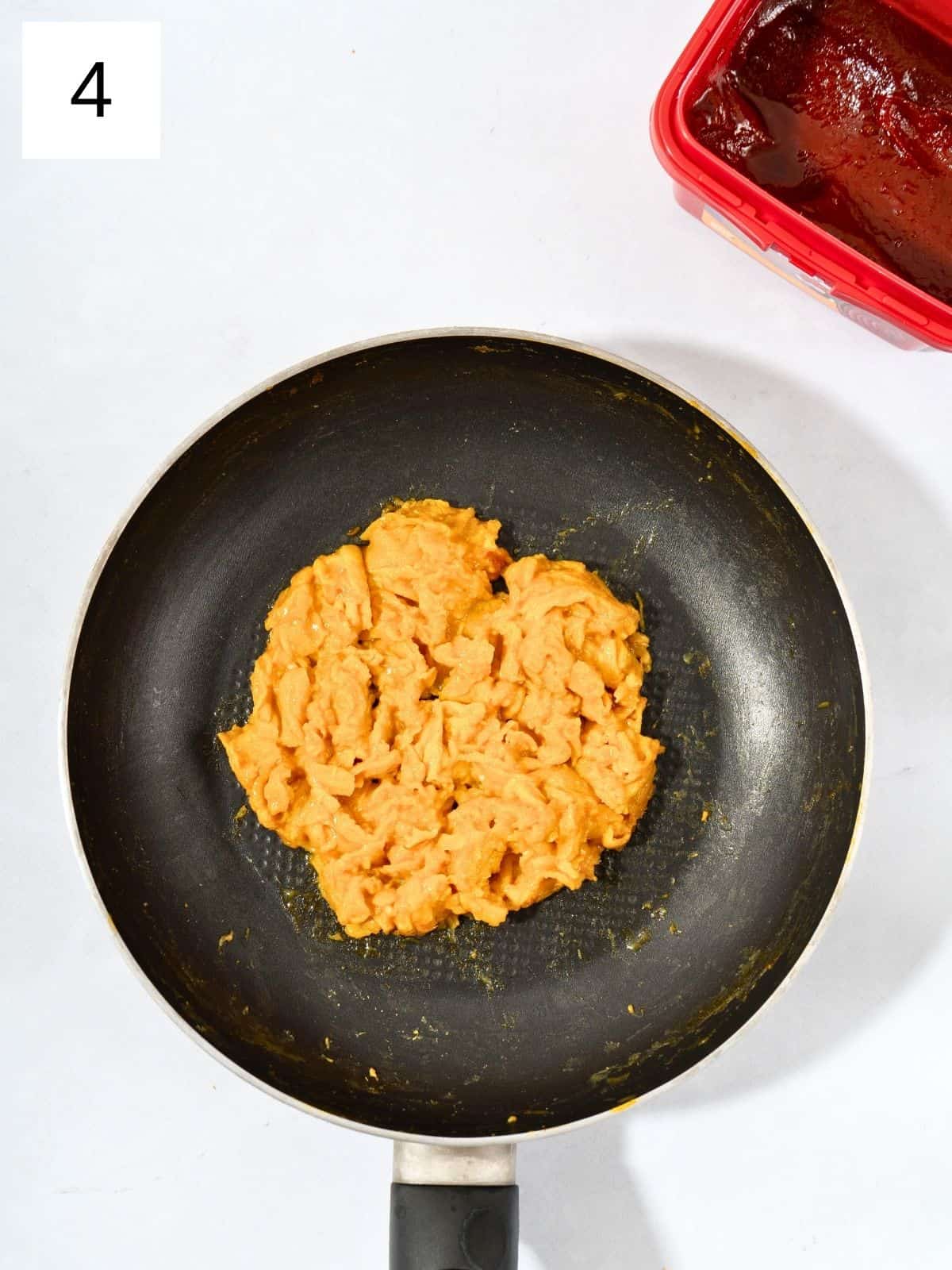 Gochujang scrambled eggs in a pan.