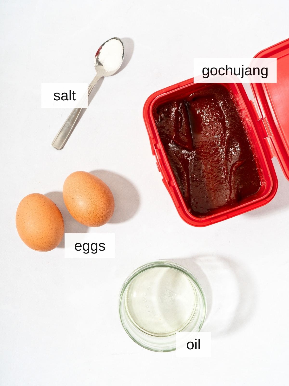 Gochujang eggs recipe ingredients including salt, gochujang, eggs, and oil.