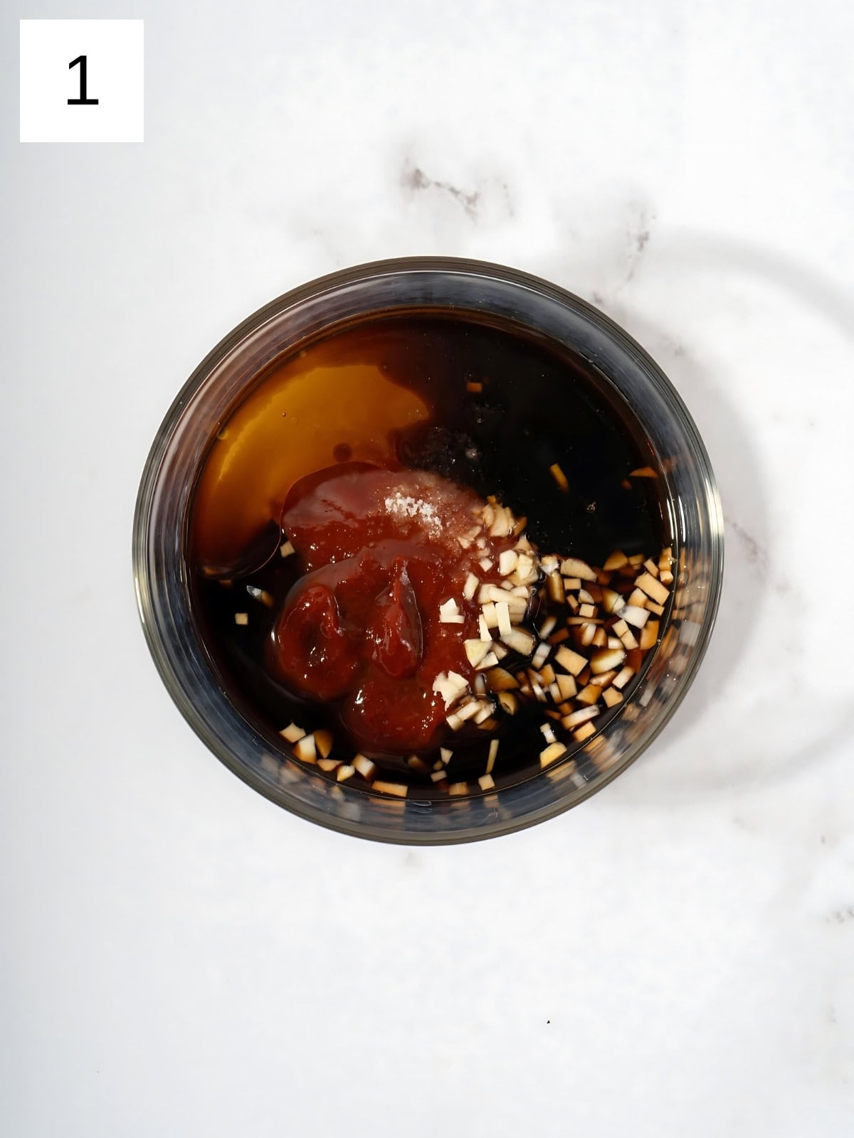 Gochujang, soy sauce, vinegar, minced garlic, sesame oil, honey, water, and salt in a small bowl.