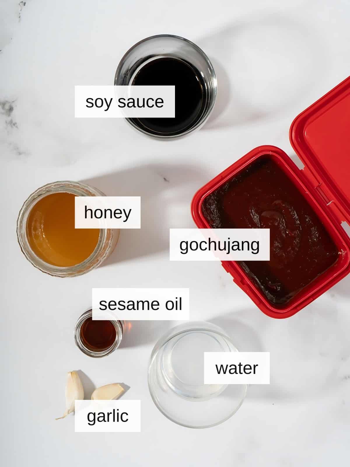 Gochujang sauce recipe ingredients including soy sauce, honey, gochujang, sesame oil, water, and garlic.