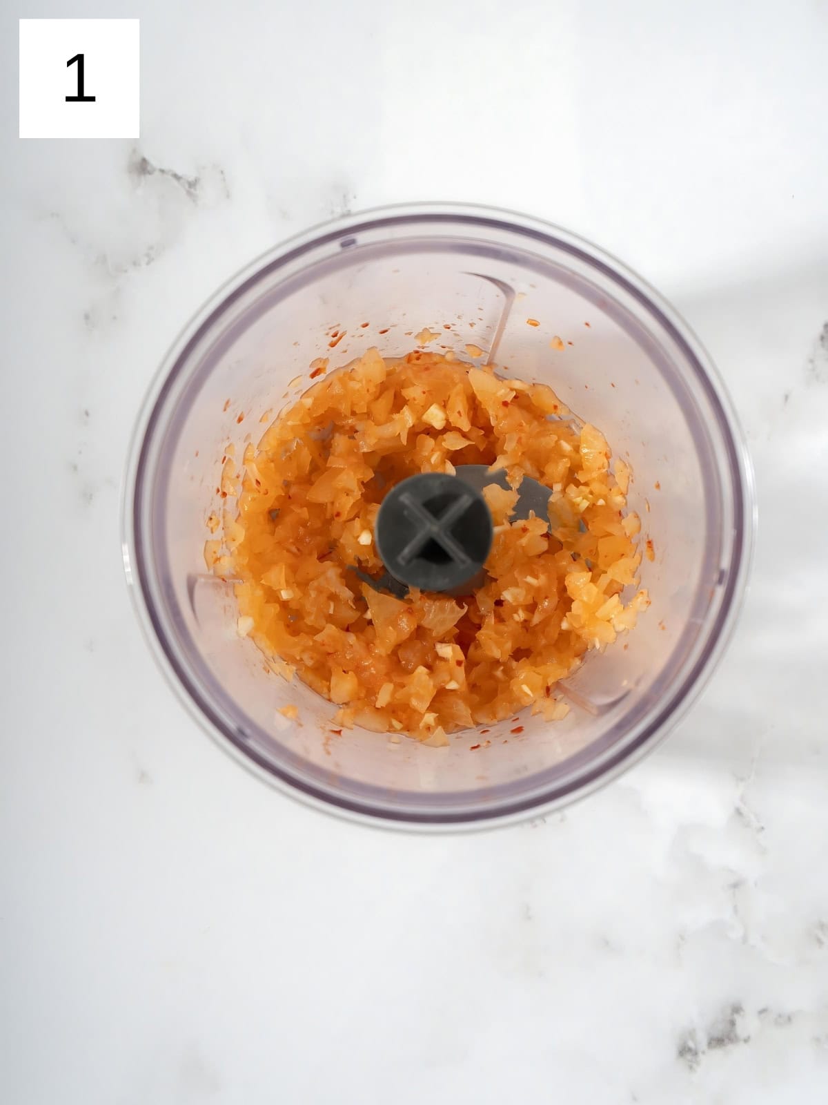 Chopped kimchi and garlic in a food processor.