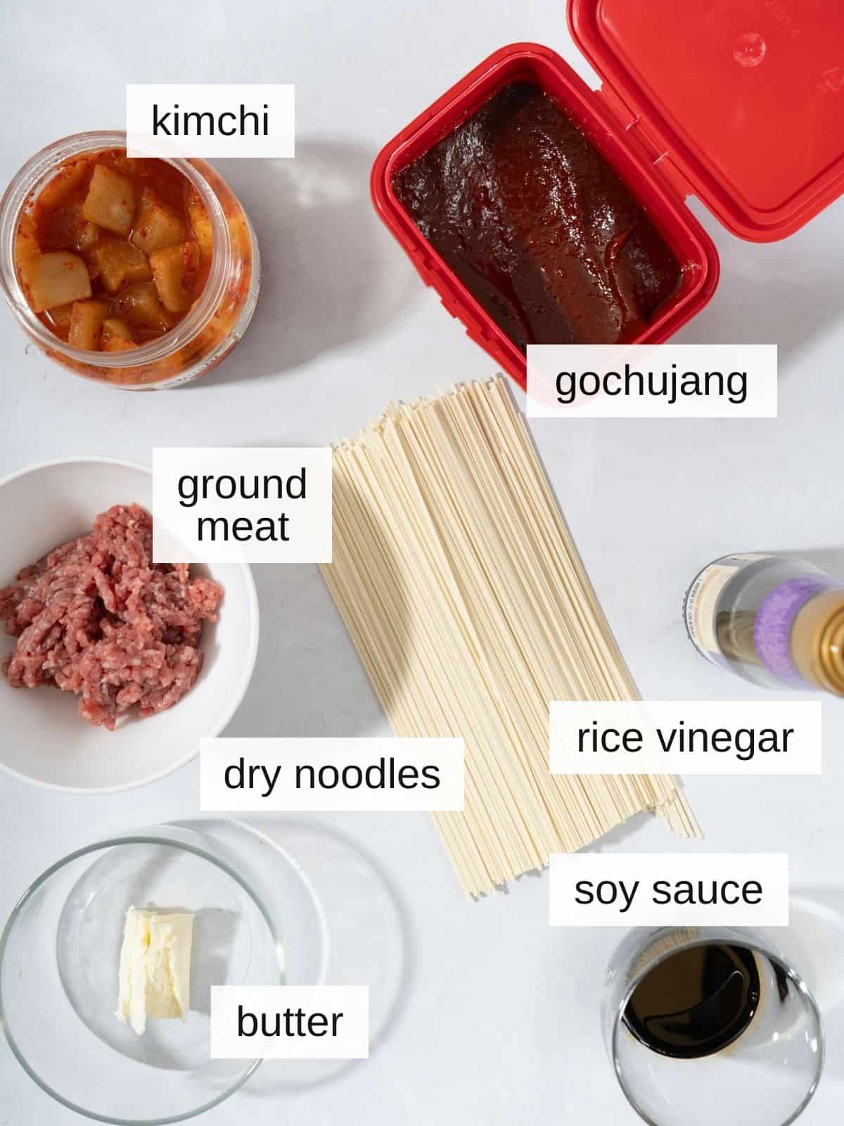 Kimchi noodles recipe ingredients including kimchi, gochujang, ground meat, rice vinegar, dry noodles, butter, and soy sauce.