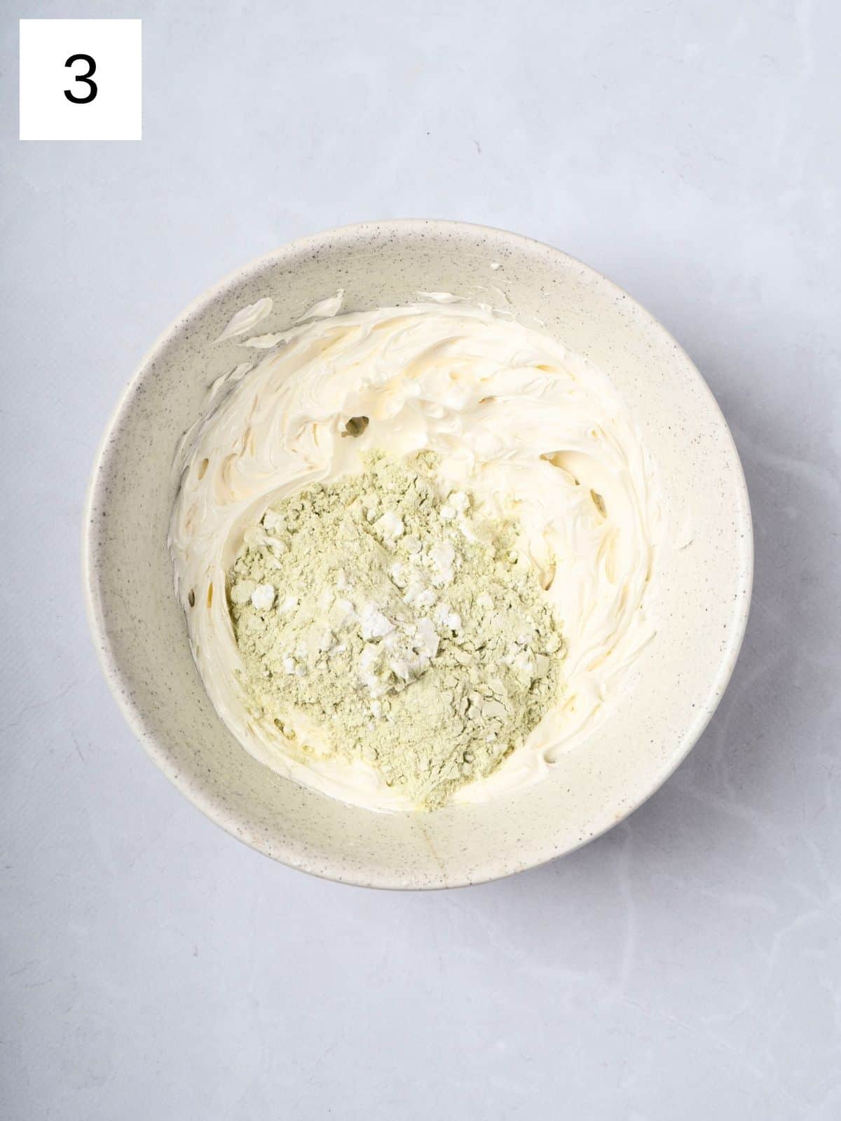 Whipped butter and matcha mixture in a bowl.