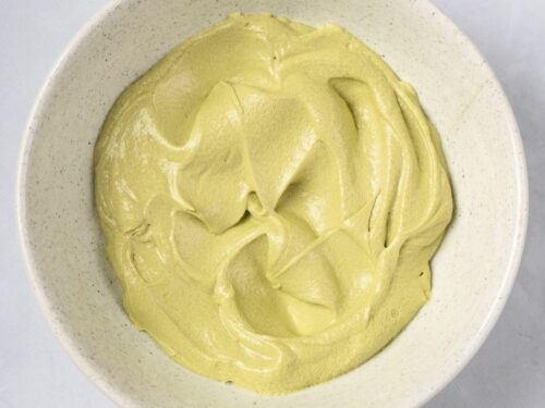 A bowl of matcha butter cream frosting.
