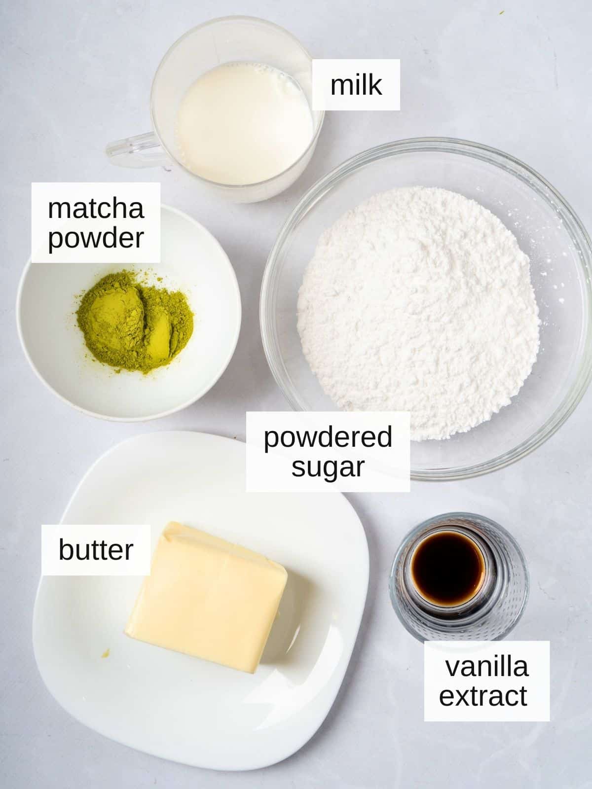 Matcha buttercream green tea frosting recipe ingredients including matcha powder, milk, butter, powdered sugar, and vanilla extract.