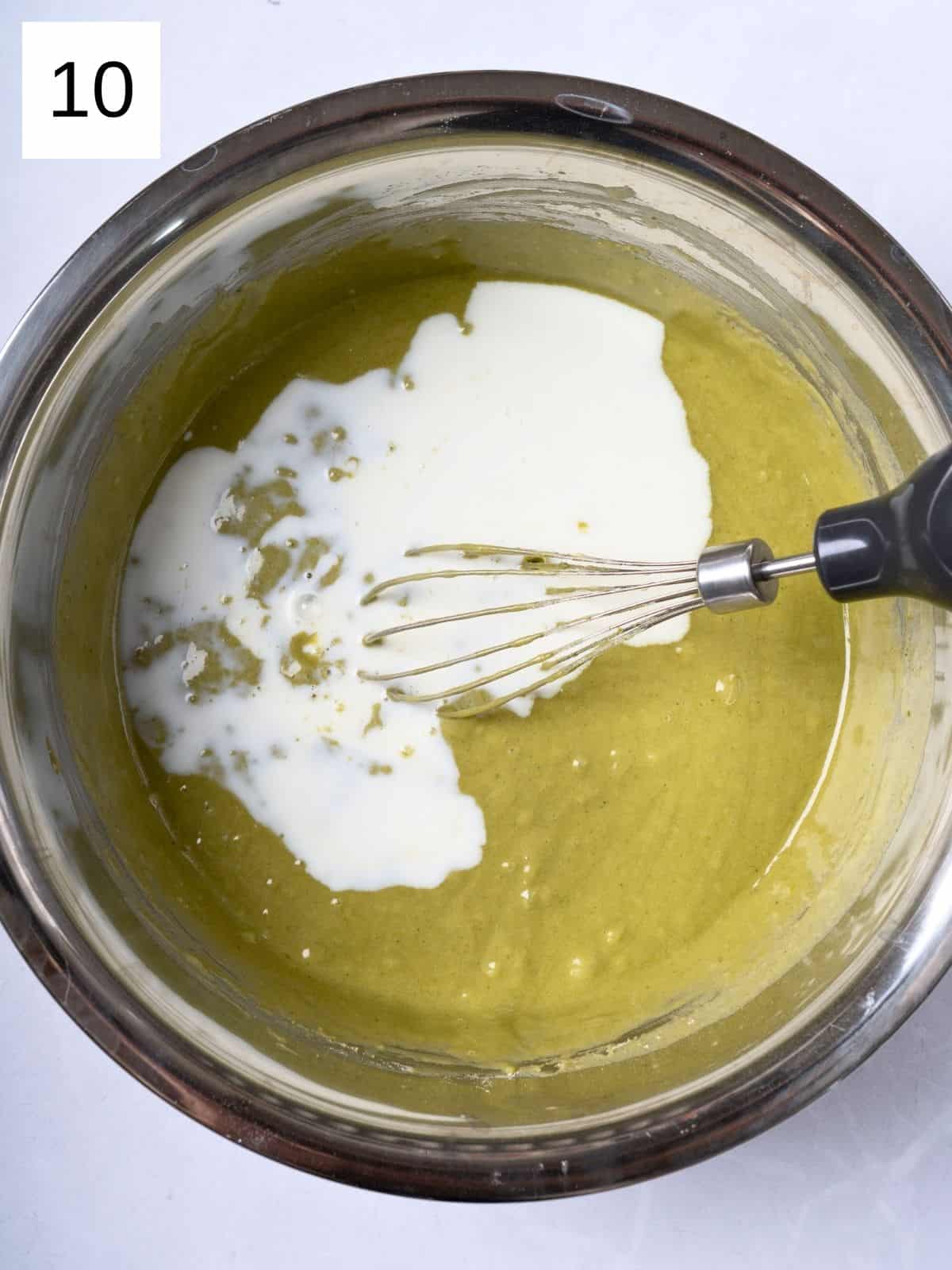 Egg and matcha mixture with added heavy cream ready to be whisked.