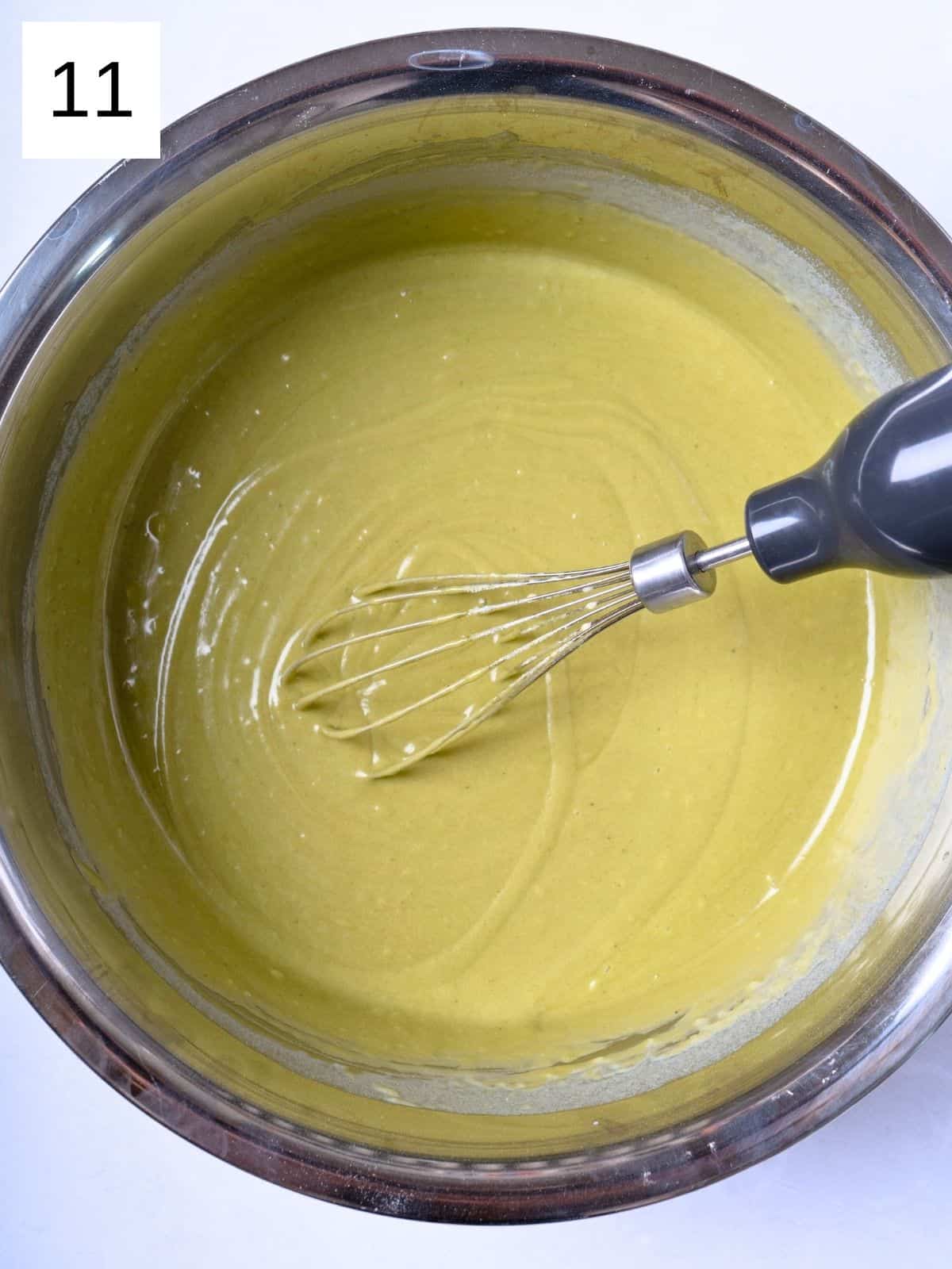 Whisked matcha batter mixture in a bowl.