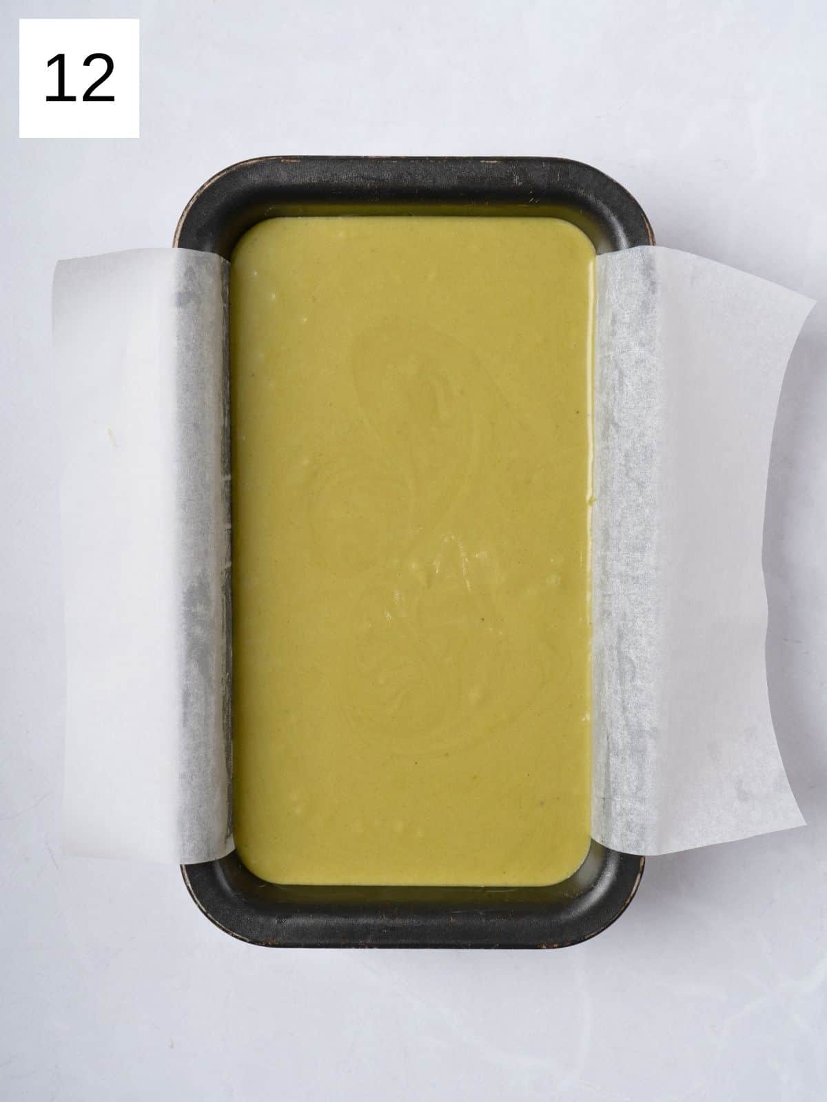 Matcha batter in a cake pan.