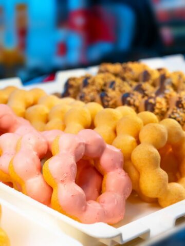 A tray of colorful mochi donuts.