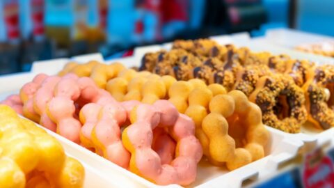 A tray of colorful mochi donuts.