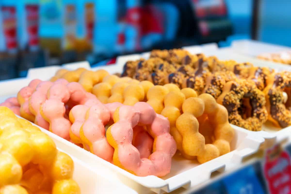 A tray of colorful mochi donuts.