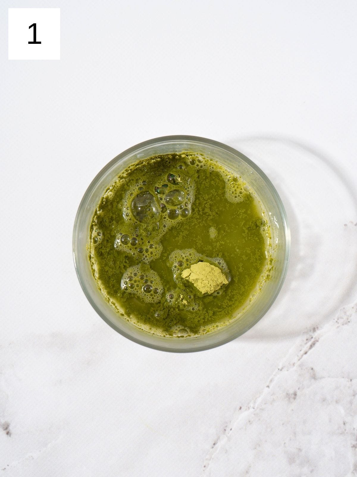 Mix matcha powder with hot water.