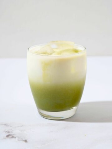 a nicely layered glass of matcha latte.