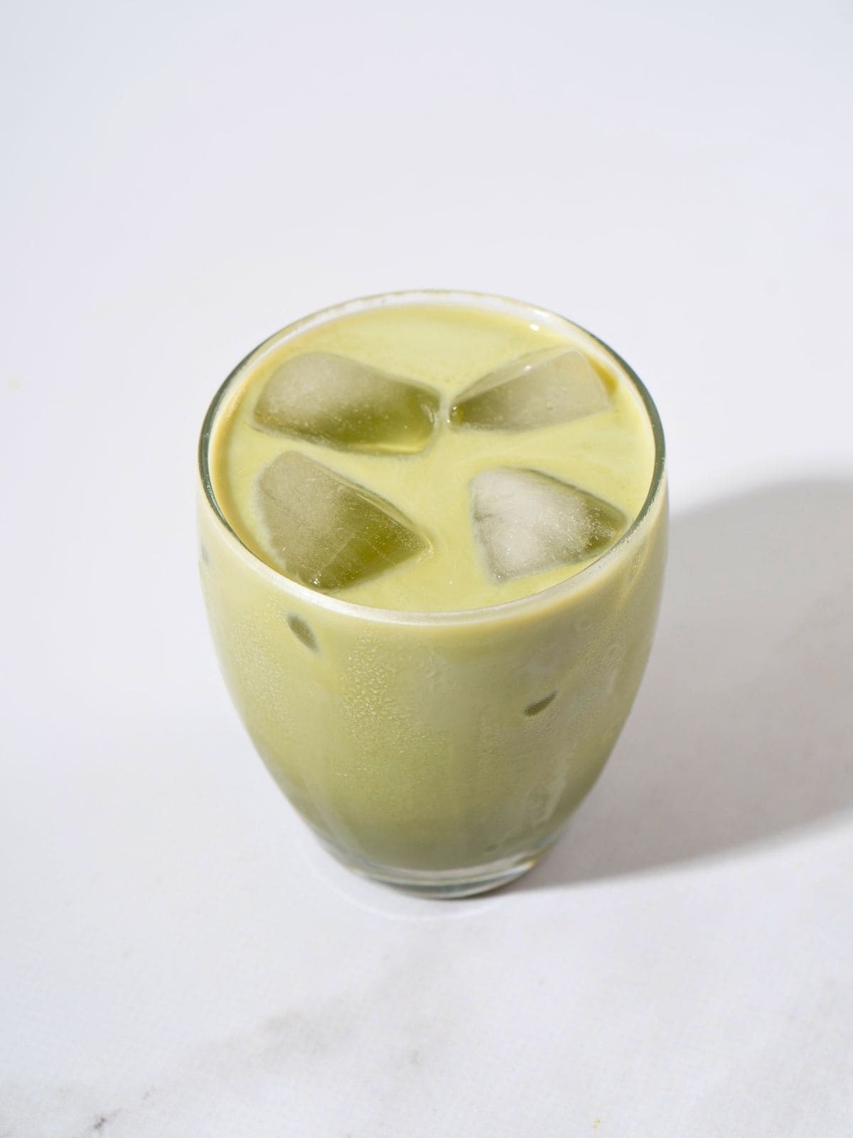 A glass of iced matcha latte.