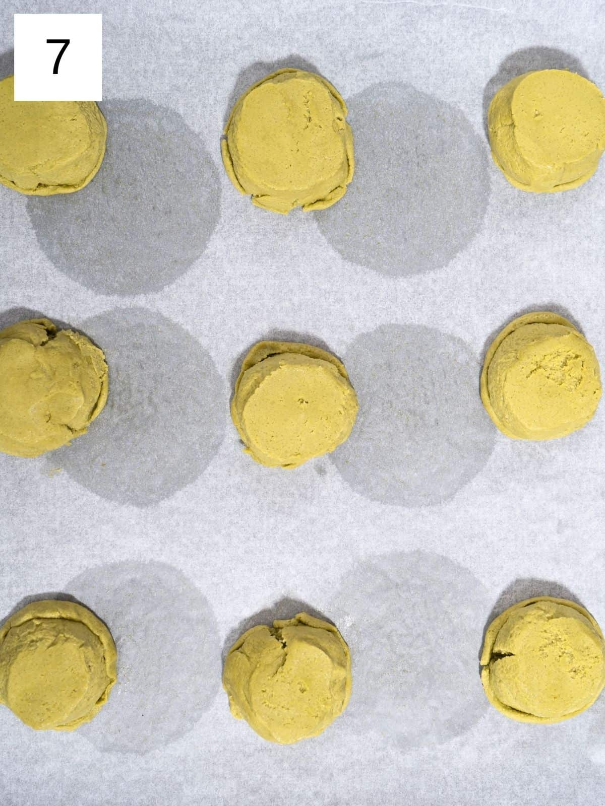 Pressed matcha cookie dough on a baking sheet.