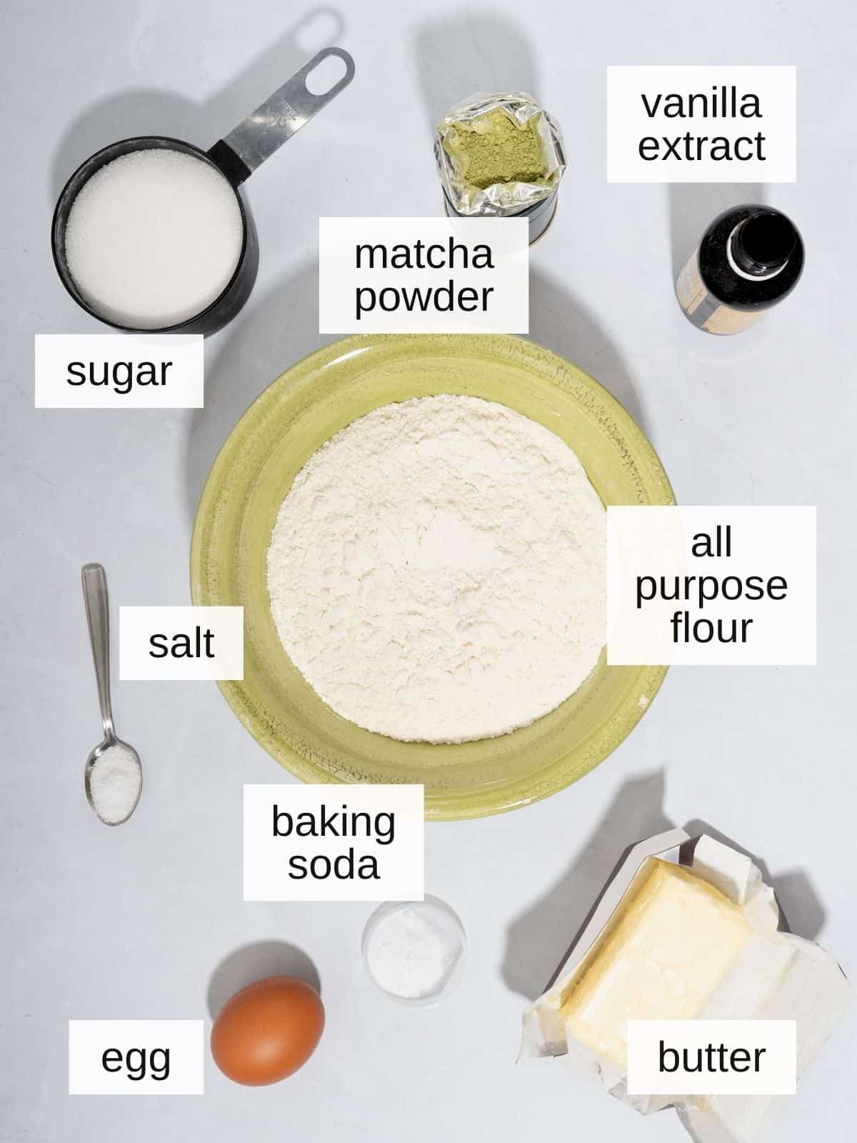 Matcha cookie recipe ingredients with vanilla extract, matcha powder, sugar, salt, all purpose flour, baking soda, egg, and butter.