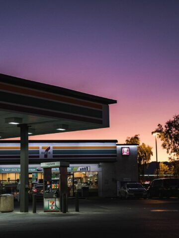 A 7-eleven store beside a gasoline station.