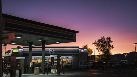 A 7-eleven store beside a gasoline station.