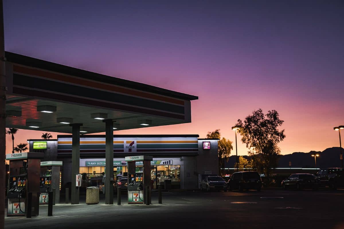 A 7-eleven store beside a gasoline station.